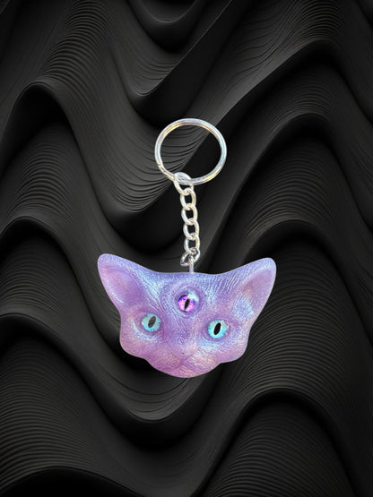 Three eyed cat keychain in purple