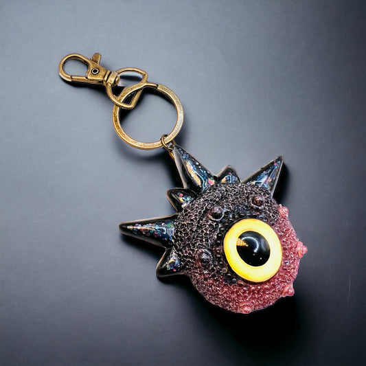 Creepy Monster Eye keychain, black and copper. Model Spiky.