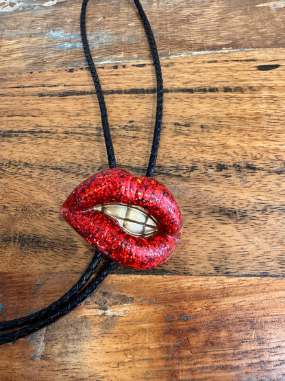 Bolo tie, sparkly red lips with gold teeth