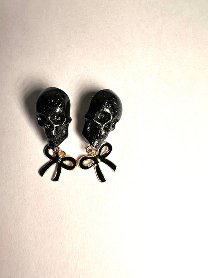 Skull with black bow and gold metal earrings studs