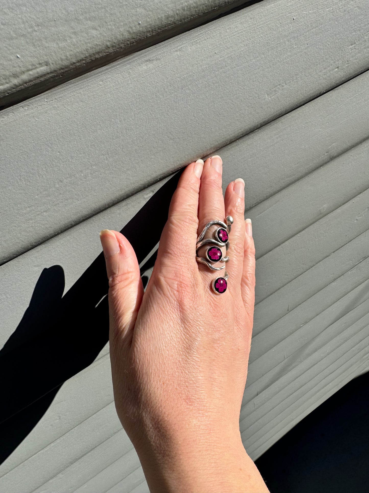 The roots ring with three pink flowers on black background