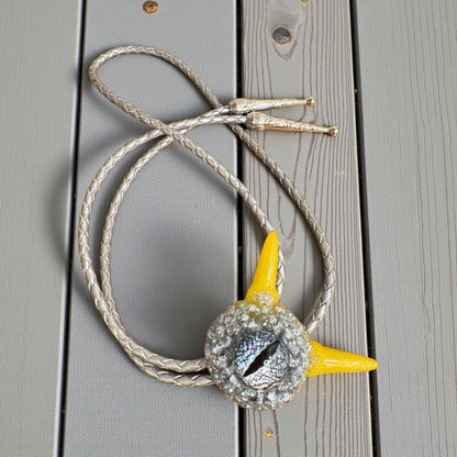 Monster bolo tie in silver and yellow. Model Pointy.