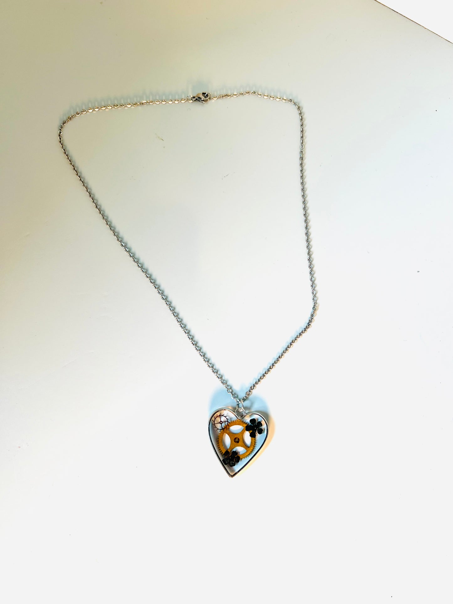 Heart necklace with black flowers and watch parts