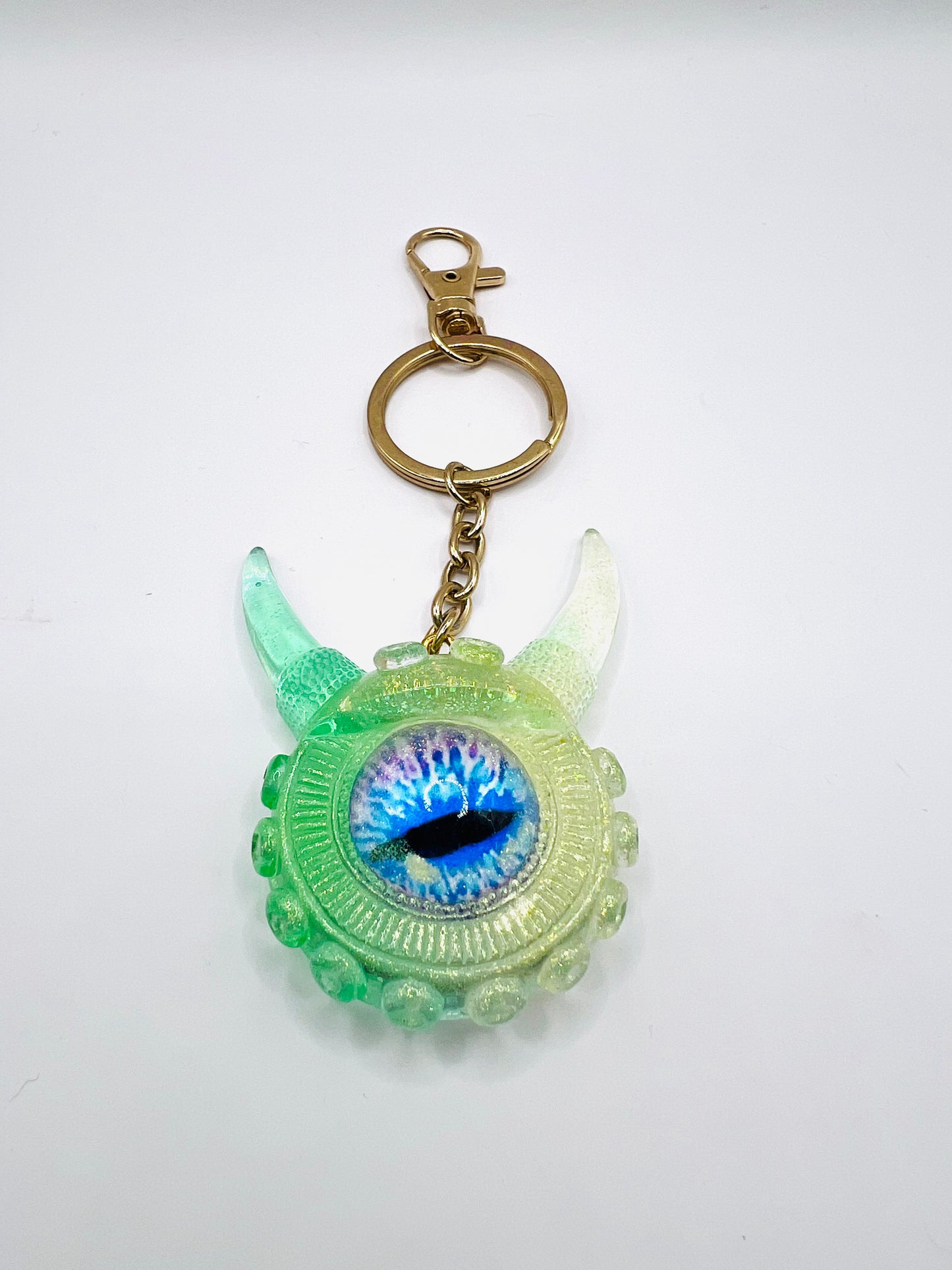 Eye catching green Monster keychain. Model Vicky.