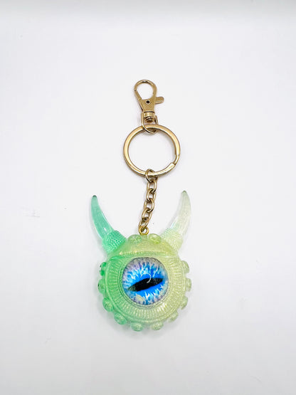 Eye catching green Monster keychain. Model Vicky.