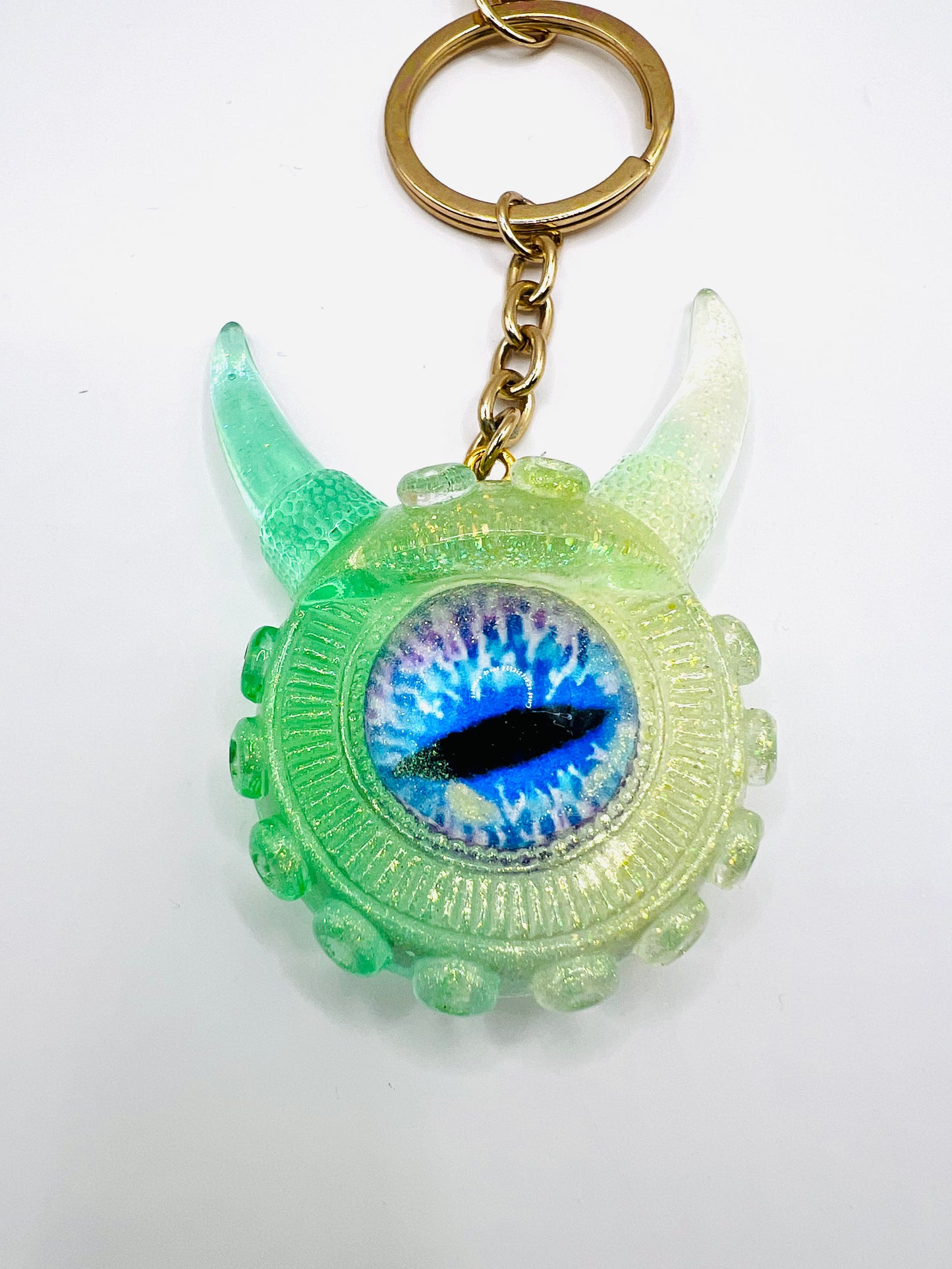 Eye catching green Monster keychain. Model Vicky.