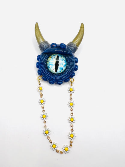 Handmade resin brooch, blue and gold monster brooch, pastel goth jewelry, evil eye brooch, weird core jewelry, kawaii brooch, unique brooch. Model Vicky.