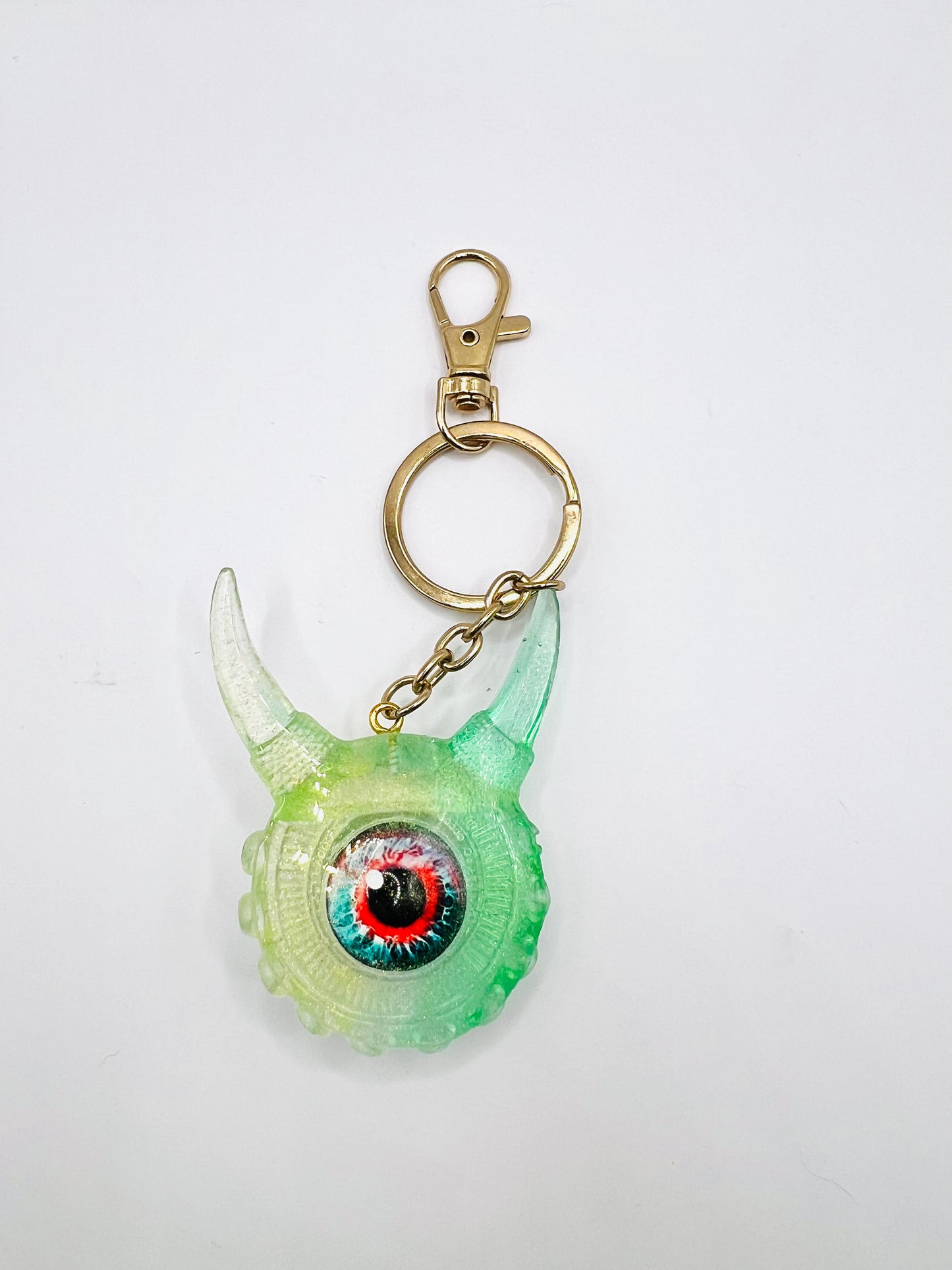 Eye catching green Monster keychain. Model Vicky.