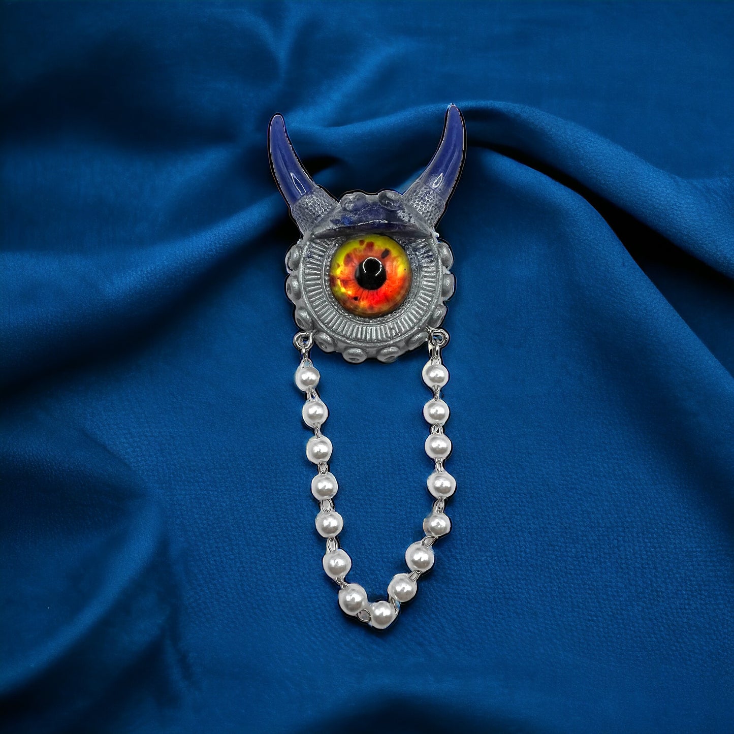 Blue and silver monster brooch. Model Vicky.