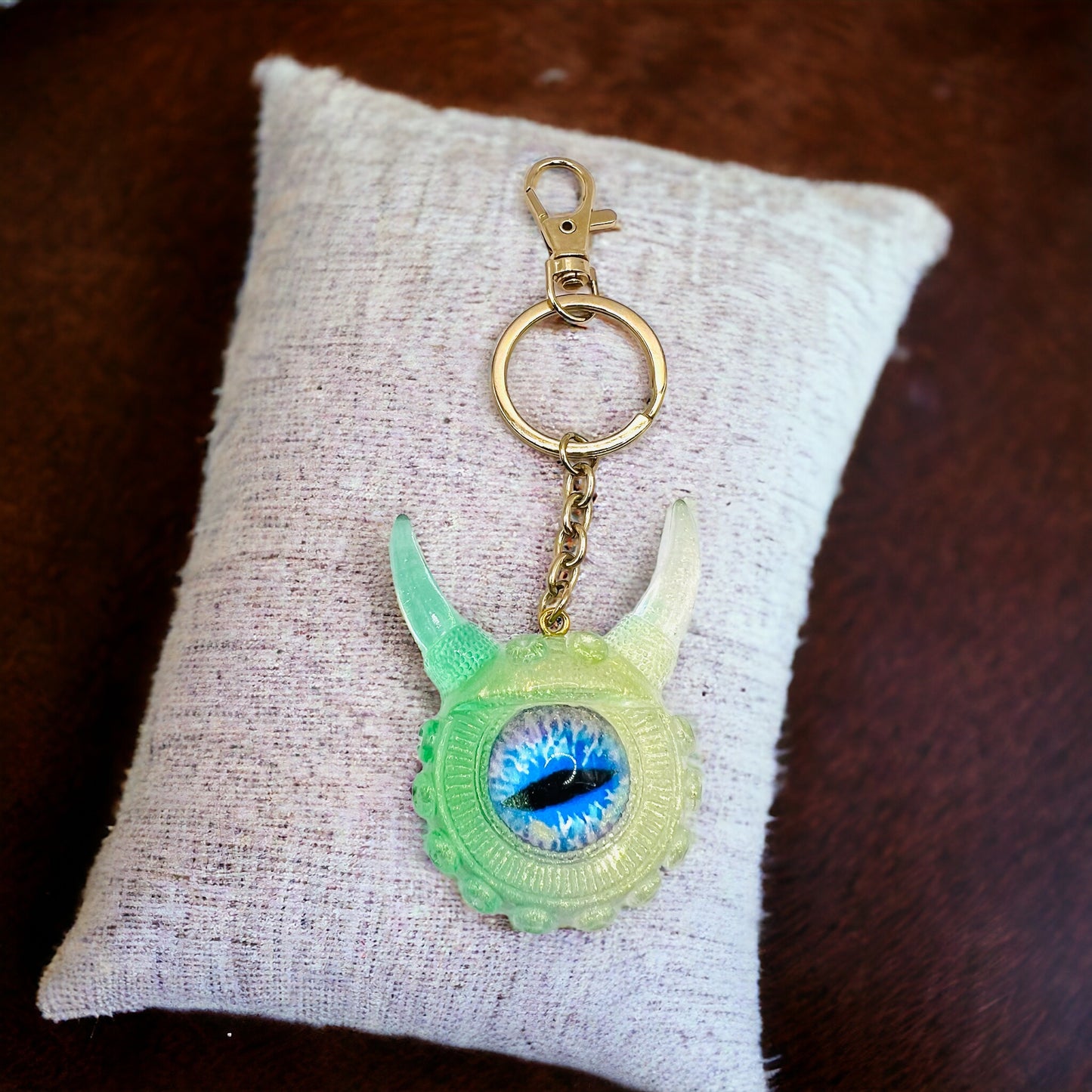 Eye catching green Monster keychain. Model Vicky.