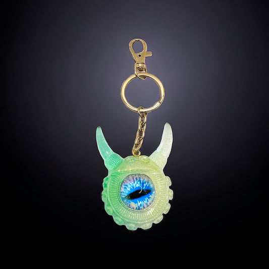 Eye catching green Monster keychain. Model Vicky.