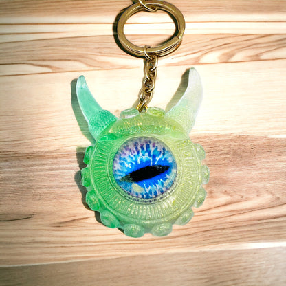 Eye catching green Monster keychain. Model Vicky.