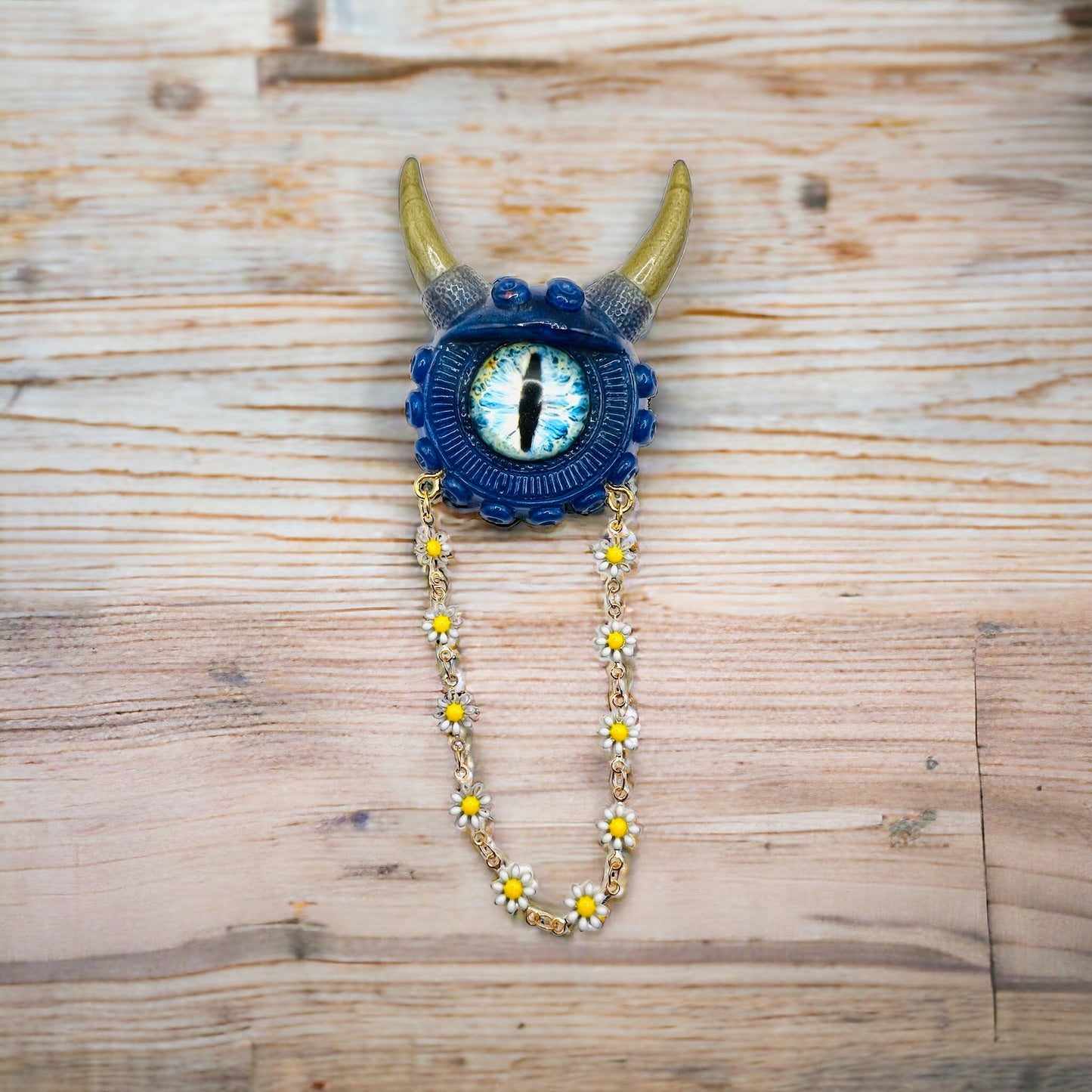 Handmade resin brooch, blue and gold monster brooch, pastel goth jewelry, evil eye brooch, weird core jewelry, kawaii brooch, unique brooch. Model Vicky.