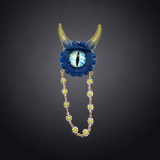 Handmade resin brooch, blue and gold monster brooch, pastel goth jewelry, evil eye brooch, weird core jewelry, kawaii brooch, unique brooch. Model Vicky.