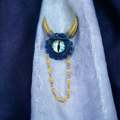 Handmade resin brooch, blue and gold monster brooch, pastel goth jewelry, evil eye brooch, weird core jewelry, kawaii brooch, unique brooch. Model Vicky.